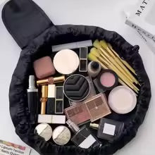Drawstring makeup bag cinched closed in hand